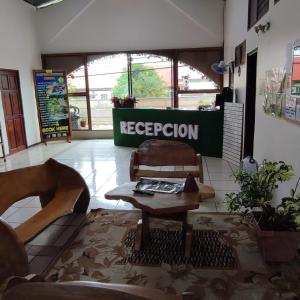 a room with a coffee table and aere operation sign in a store at Sleeping Mountain Arenal in Fortuna