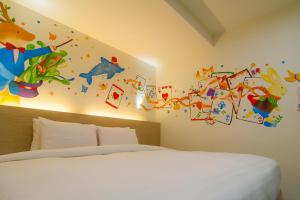 Postel nebo postele na pokoji v ubytování Legend Hotel Kaohsiung Liuhe
