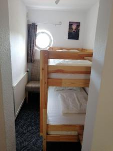 two bunk beds in a small room with a window at Bungalow in Kritzmow