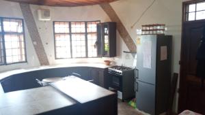 a kitchen with a refrigerator and a stove at Ocean Gaze in Accra