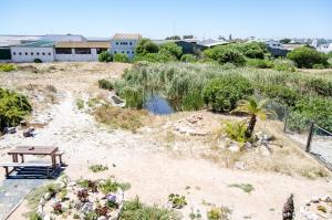 a park with a picnic table and a pond at Red Bishop - Birds, Beach & Beauty in Langebaan