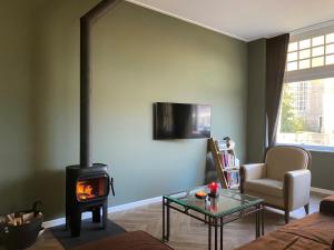 a living room with a wood stove in a living room at Appartement "Hartje Haamstede" in Burgh Haamstede