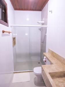 a bathroom with a shower and a toilet at Pousada Das Roseiras in Barra Grande +33 photos