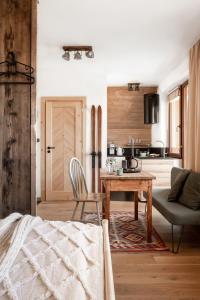 a living room with a table and a chair at TATRA REST in Kościelisko