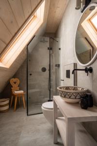 a bathroom with a shower and a sink and a toilet at TATRA REST in Kościelisko