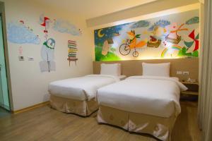 Postel nebo postele na pokoji v ubytování Legend Hotel Kaohsiung Liuhe