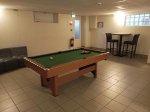 a room with a pool table in a room at o'ptit hôtel in Trévé