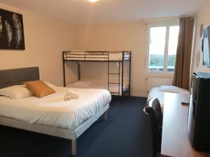 Postel nebo postele na pokoji v ubytování o'ptit hôtel