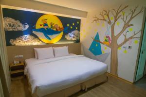 Postel nebo postele na pokoji v ubytování Legend Hotel Kaohsiung Liuhe