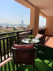a patio with a table and chairs on a balcony at Anantara Luxury Hotel Apartment & Residences conected Anantara Hotel in Dubai