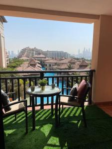 a balcony with a table and chairs and a view of the city at Anantara Luxury Hotel Apartment & Residences conected Anantara Hotel in Dubai