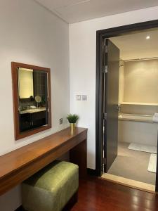 a bathroom with a glass door and a mirror at Anantara Luxury Hotel Apartment & Residences conected Anantara Hotel in Dubai