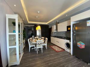 a kitchen and dining room with a table and chairs at Ritala Royal Residence in Amman