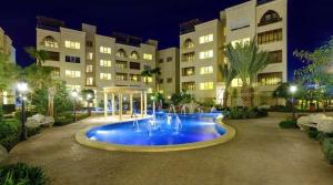 a large building with a fountain in front of it at Ritala Royal Residence in Amman