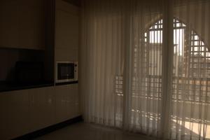 a room with a window with white curtains at Ritala Royal Residence in Amman