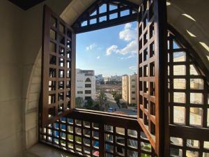 a window view of a city from a building at Ritala Royal Residence in Amman