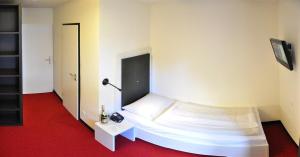 Postel nebo postele na pokoji v ubytování Amiga Hotel München Messe