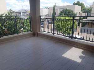 a balcony with a fence and a view of a street at Adorable 3 bedroom Brenner "Hill" suite in Giv‘at Brenner