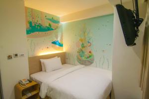Postel nebo postele na pokoji v ubytování Legend Hotel Kaohsiung Liuhe