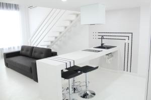 a kitchen with a black couch and a kitchen island at Luxury Apartments in Odesa