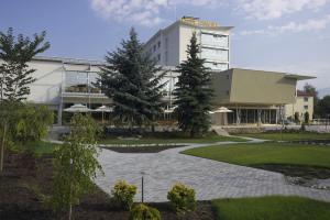 a building with a walkway in front of a building at Hotel Janosik in Liptovský Mikuláš