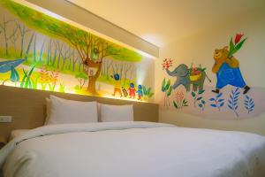 Postel nebo postele na pokoji v ubytování Legend Hotel Kaohsiung Liuhe