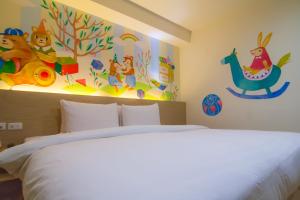 Postel nebo postele na pokoji v ubytování Legend Hotel Kaohsiung Liuhe