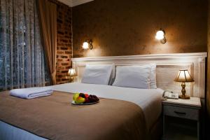 a bedroom with a bed with a bowl of fruit on it at Sultanahmet Suites in Istanbul