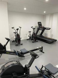a gym with several cardio bikes in a room at Brand new luxury apartment with free parking and gym in Olton