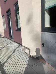 a shadow of a person on the side of a building at Brand new luxury apartment with free parking and gym in Olton
