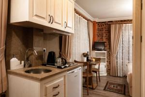 a small kitchen with a sink and a table at Sultanahmet Suites in Istanbul