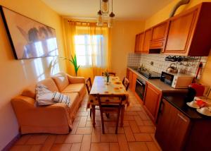 a kitchen with a couch and a table in a kitchen at LEONÄRDO Guests House in Panicale