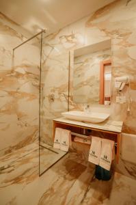 a bathroom with a sink and a shower at Martiness Hotel Durres in Durrës