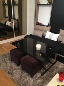 a room with a vanity with two mirrors and a stool at STUDIO COSY MONTPARNASSE in Paris