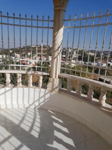 a balcony with a view of a city at Ibbin hospitality house in Ajloun