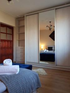 a bedroom with a bed and a large mirror at Apartament Leśny in Nowy Targ