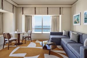 a living room filled with furniture and a large window at Four Seasons Hotel Miami in Miami