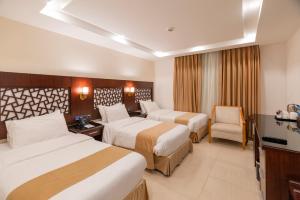 Postel nebo postele na pokoji v ubytování Petra Elite Hotel