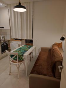 a living room with a table and a couch at Lux apartment, near metro Vasylkivska in Kyiv