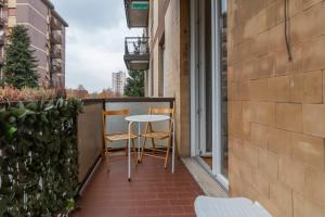 a balcony with two chairs and a table at [Mimmi Apartment] Zurigo 12 in Milan