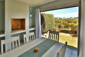 a dining room with a table and a fireplace at Bella Casa in Langebaan