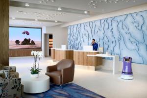 a man sits at a reception desk in a dental office at LUMA Hotel San Francisco - #1 Hottest New Hotel in the US in San Francisco