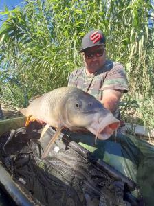 a man holding a large fish with a gun at R U Ready Fishing, River Ebro in Mequinenza