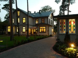 a house with a brick driveway in front of it at Apartments Livia in Jūrmala