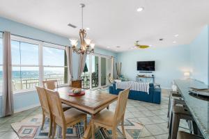 a dining room with a table and chairs and a couch at Turtle Ridge in Pensacola Beach