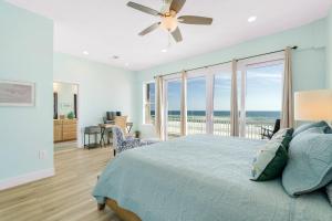 a bedroom with a bed and a view of the ocean at Turtle Ridge in Pensacola Beach