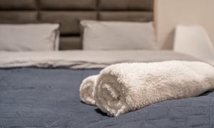 a white towel is laying on a bed at New Gudauri, Loft 1, Kato 236 in Gudauri