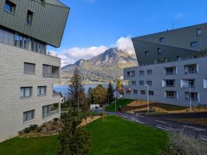 a view of the mountains from between two buildings at Reflet du Parmelan Annecy in Annecy