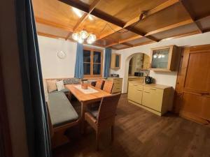 a kitchen with a table and a dining room at Haus Kreuzboden in Hundsdorf