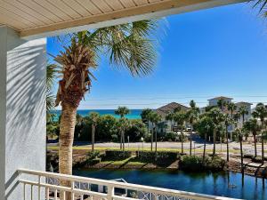 a view of a palm tree from a balcony at Cabana's @ Gulf Place #308 in Santa Rosa Beach